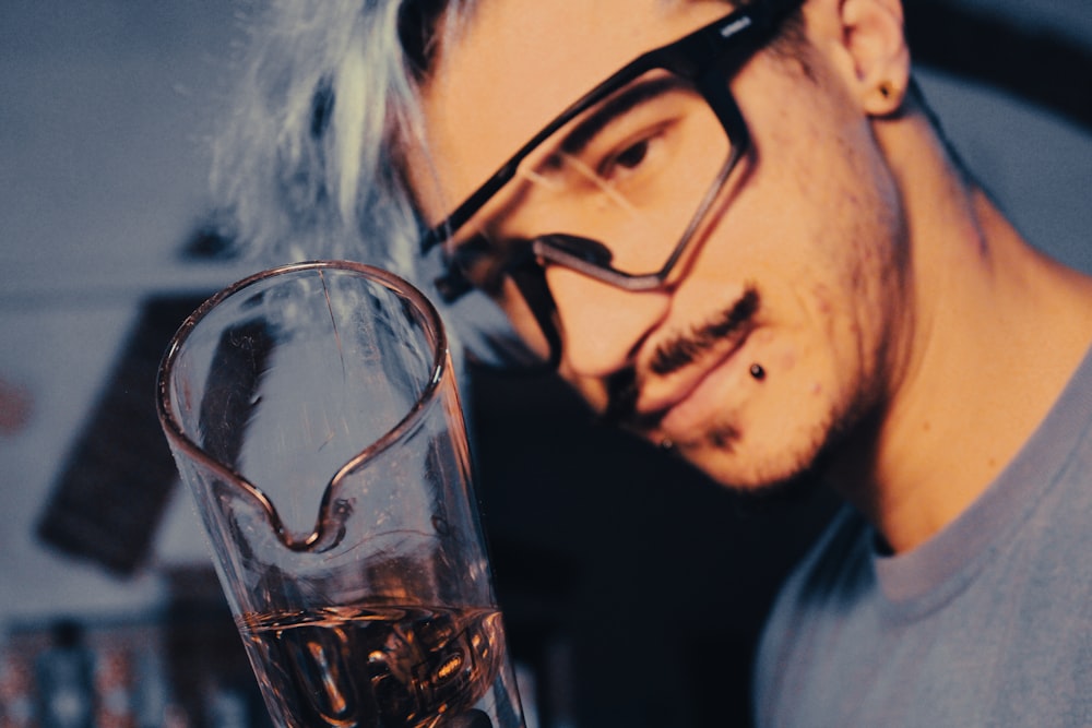 a man with glasses and a drink