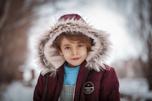 a boy wearing a furry hat