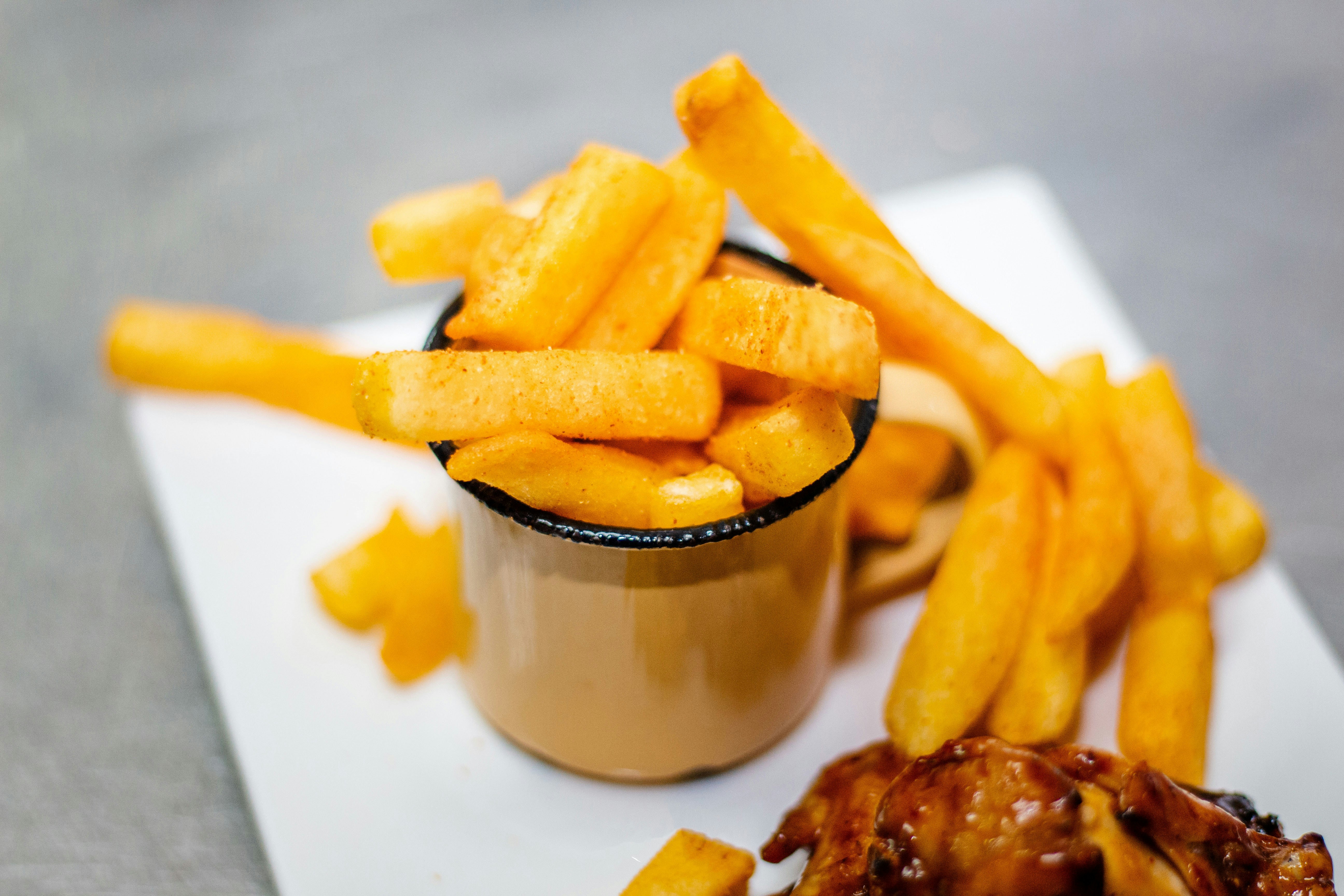 Thick chips in a cup with sauce