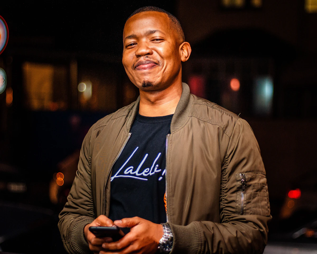 Man holding his phone, about to text a girl after getting her number