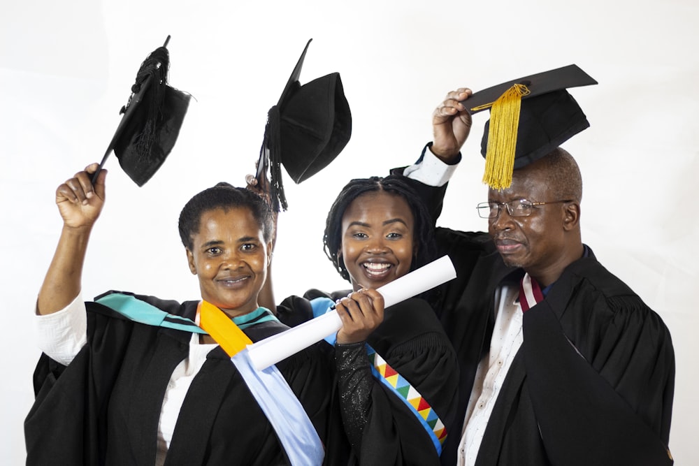 a group of people holding graduation caps