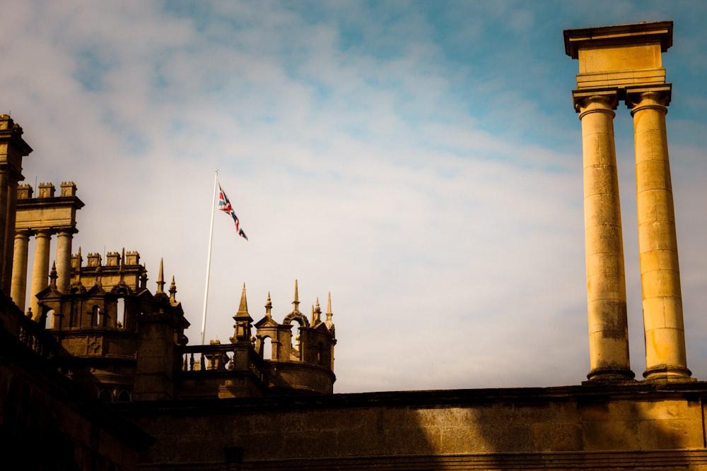 a building with towers and a flag