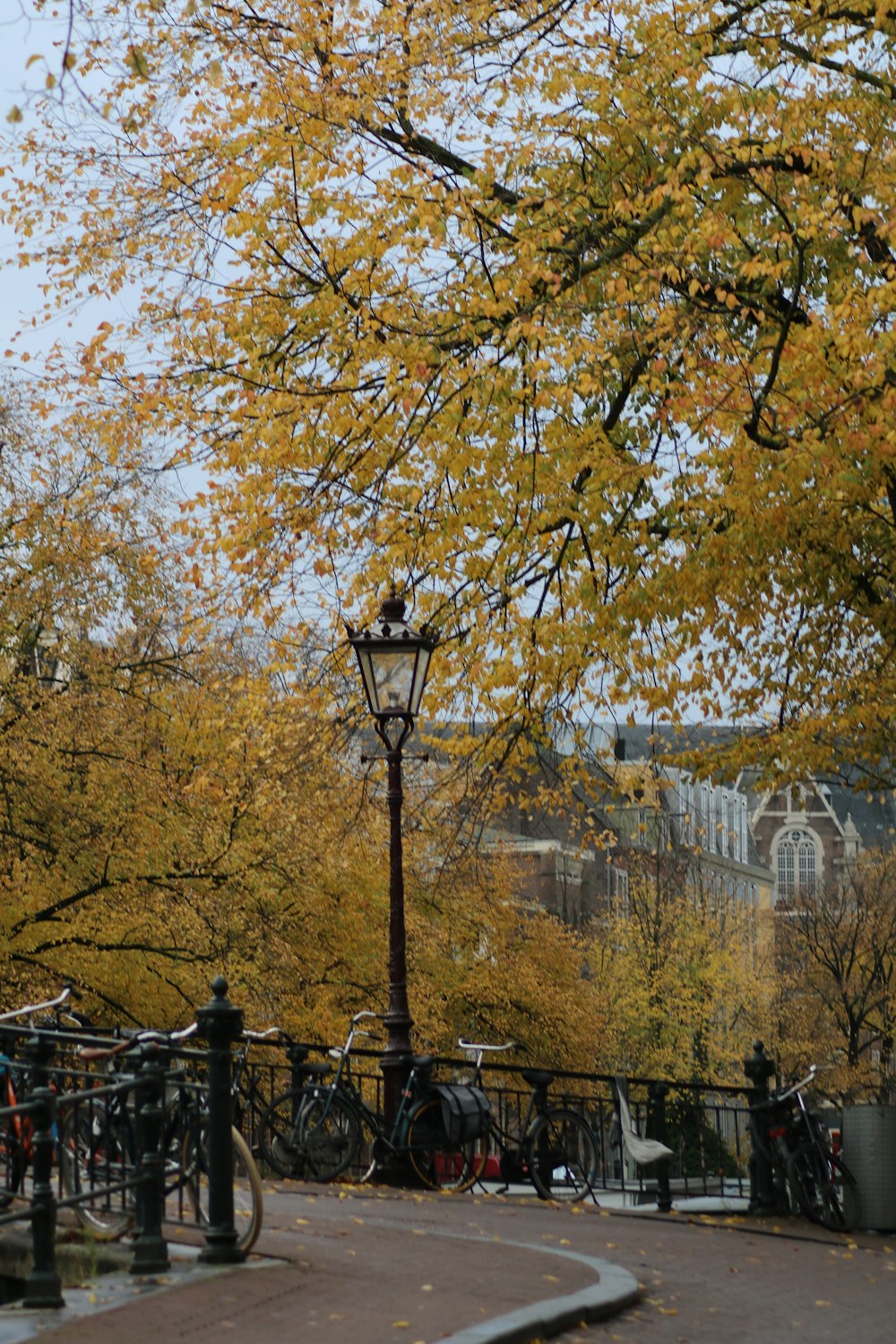 a lamp post with a lamp post and trees in the background