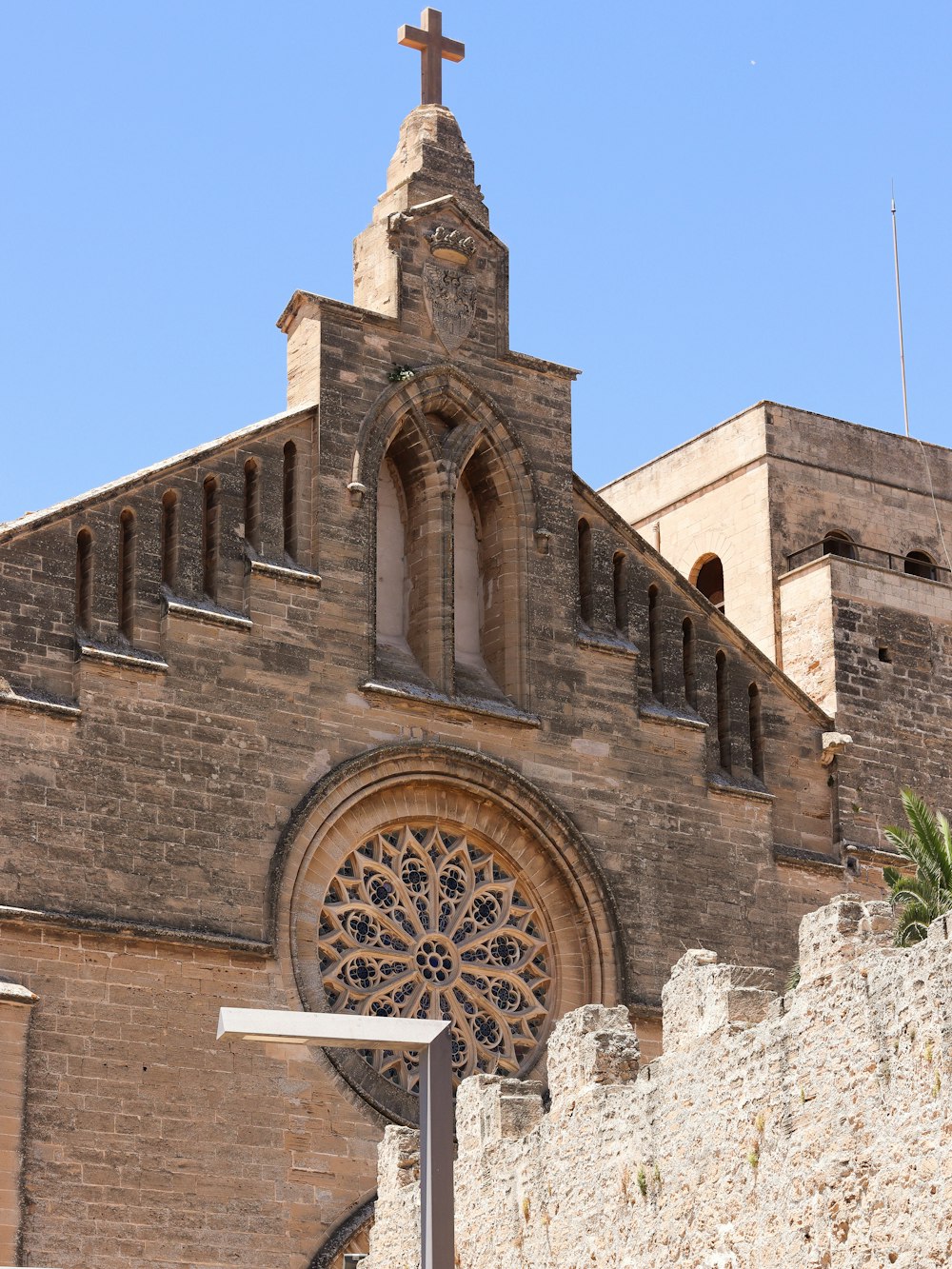 a large brick building with a cross on top