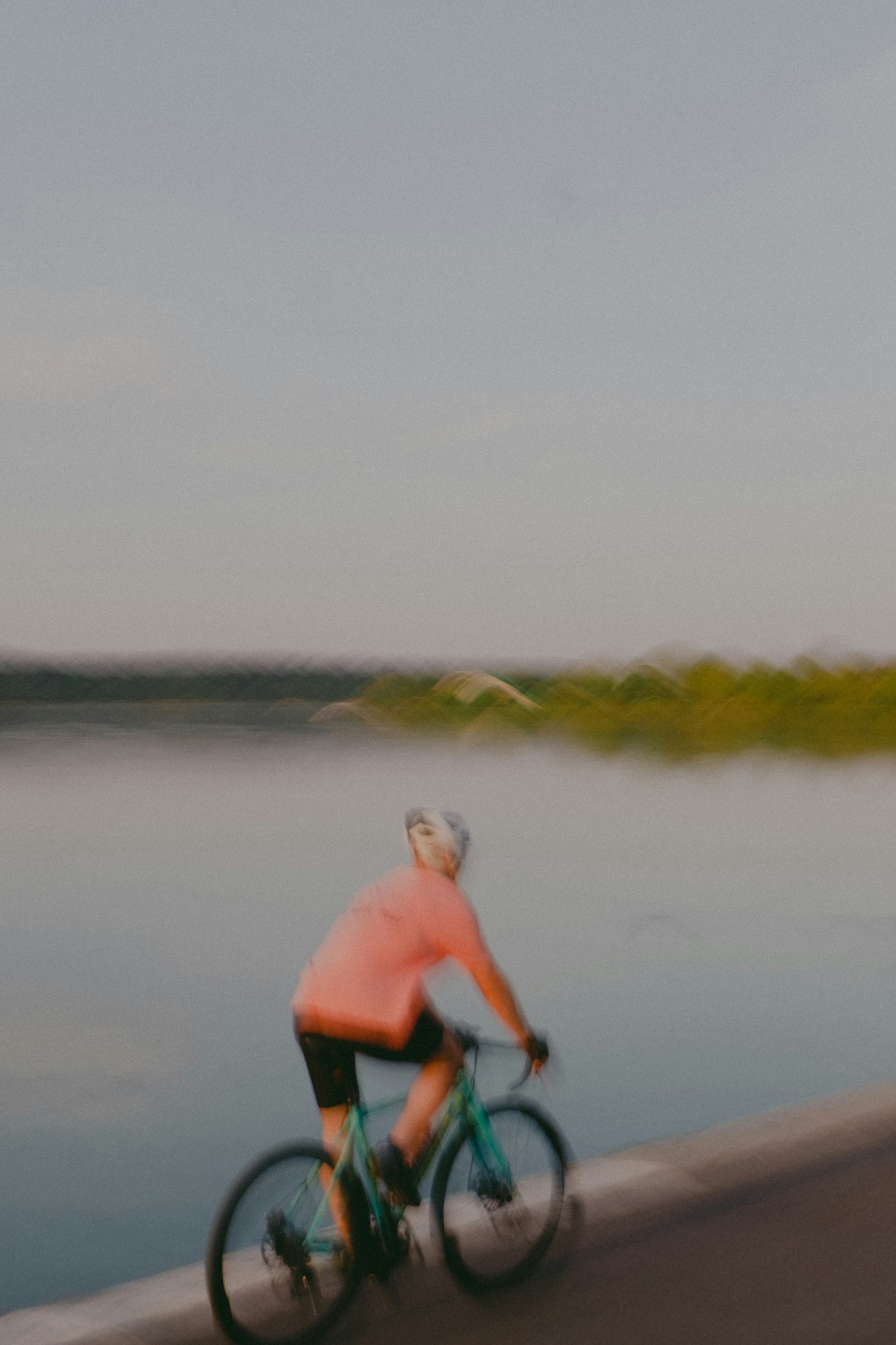 a person riding a bicycle on a beach