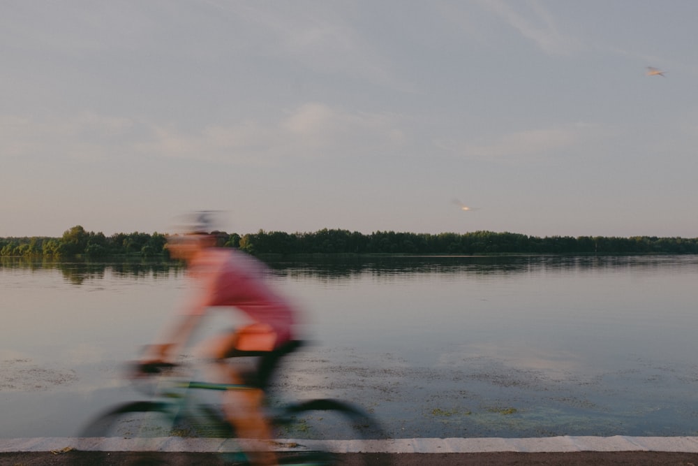 a person riding a bicycle on a lake