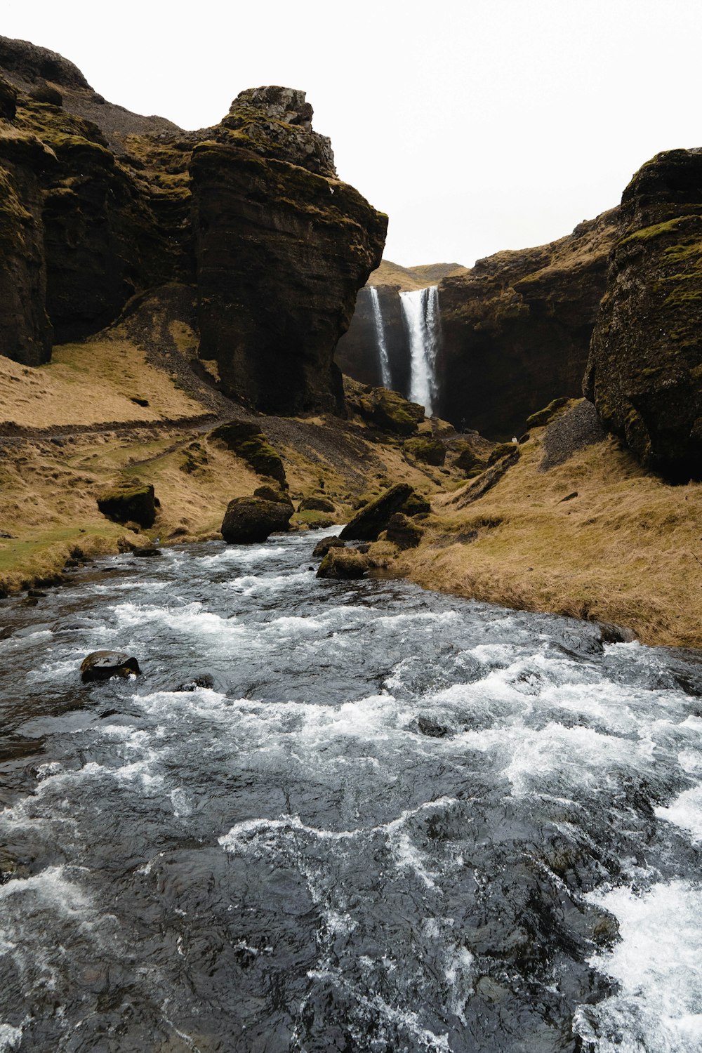 a waterfall in a rocky canyon