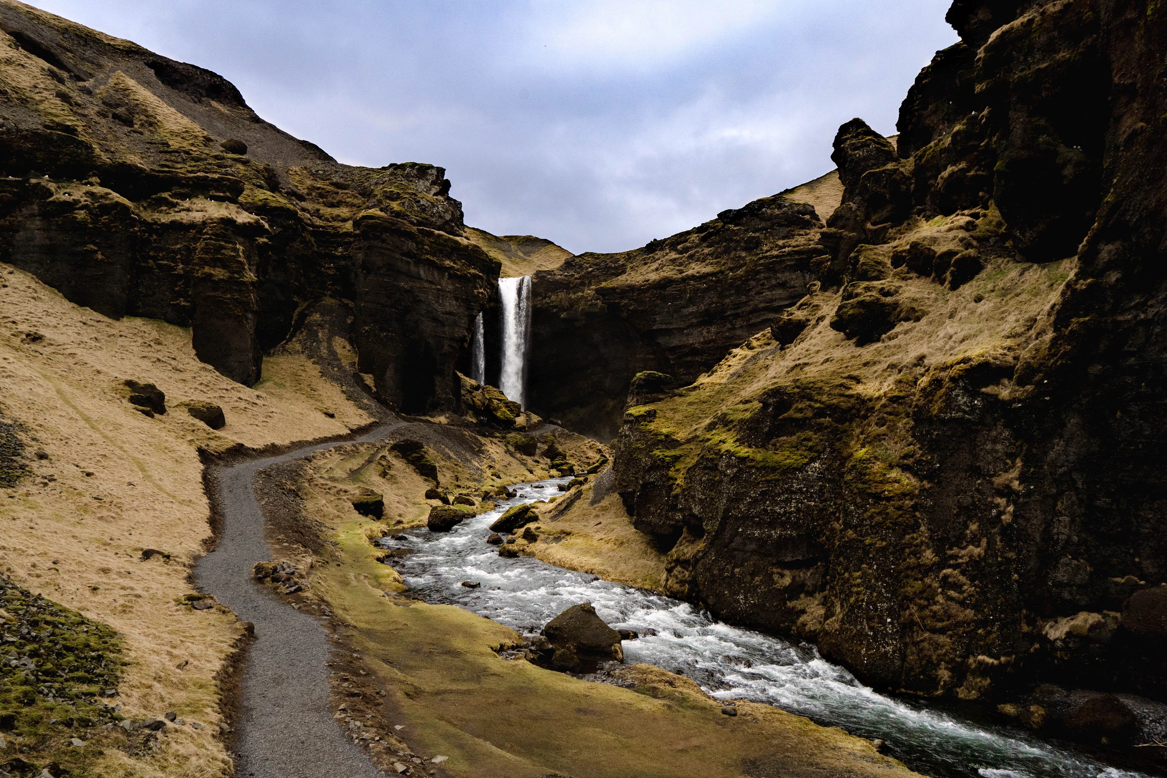 Kvernufoss waterfall falling into a rocky, moss-green canyon in southern Iceland