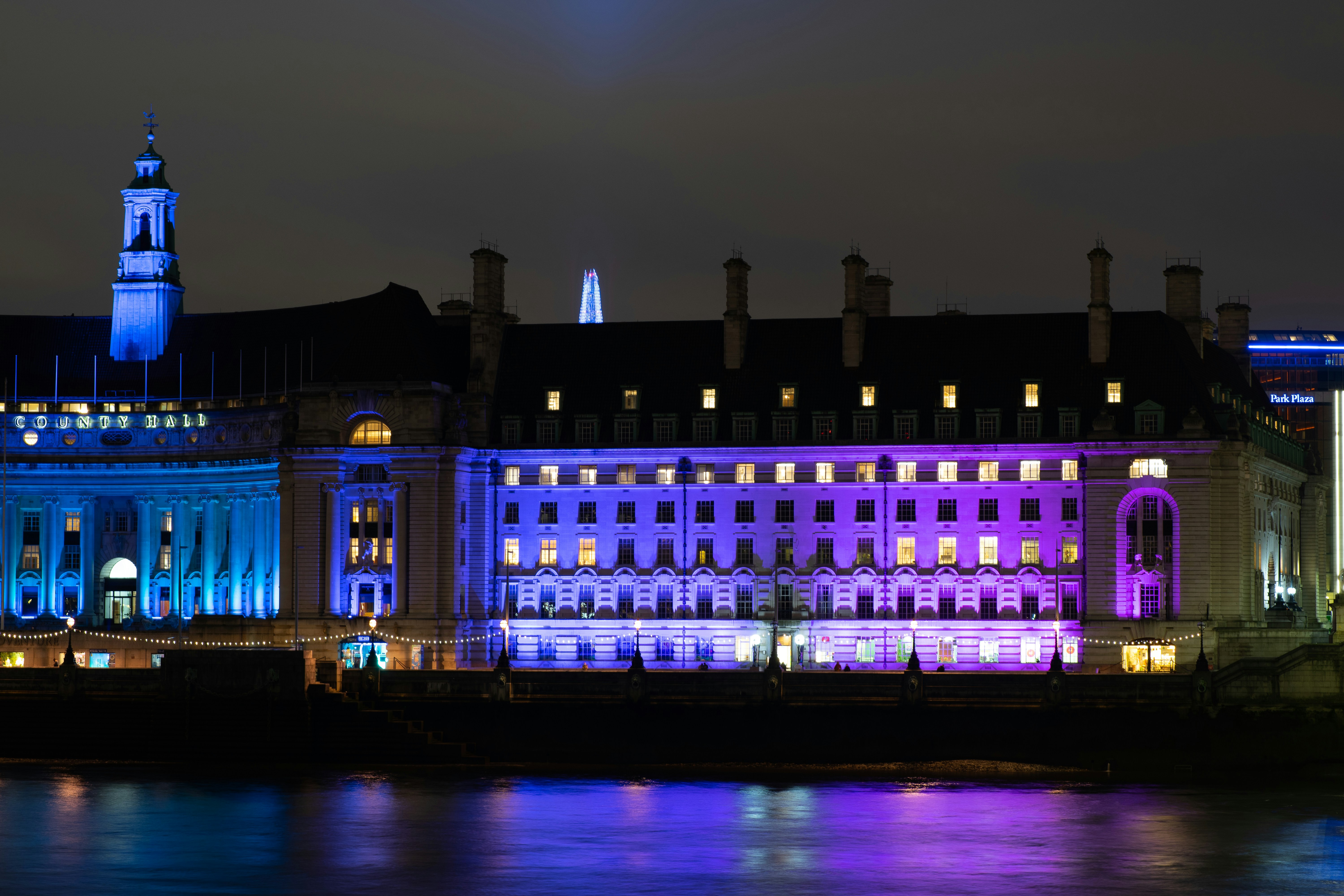 a building with a tower and a body of water in front of it