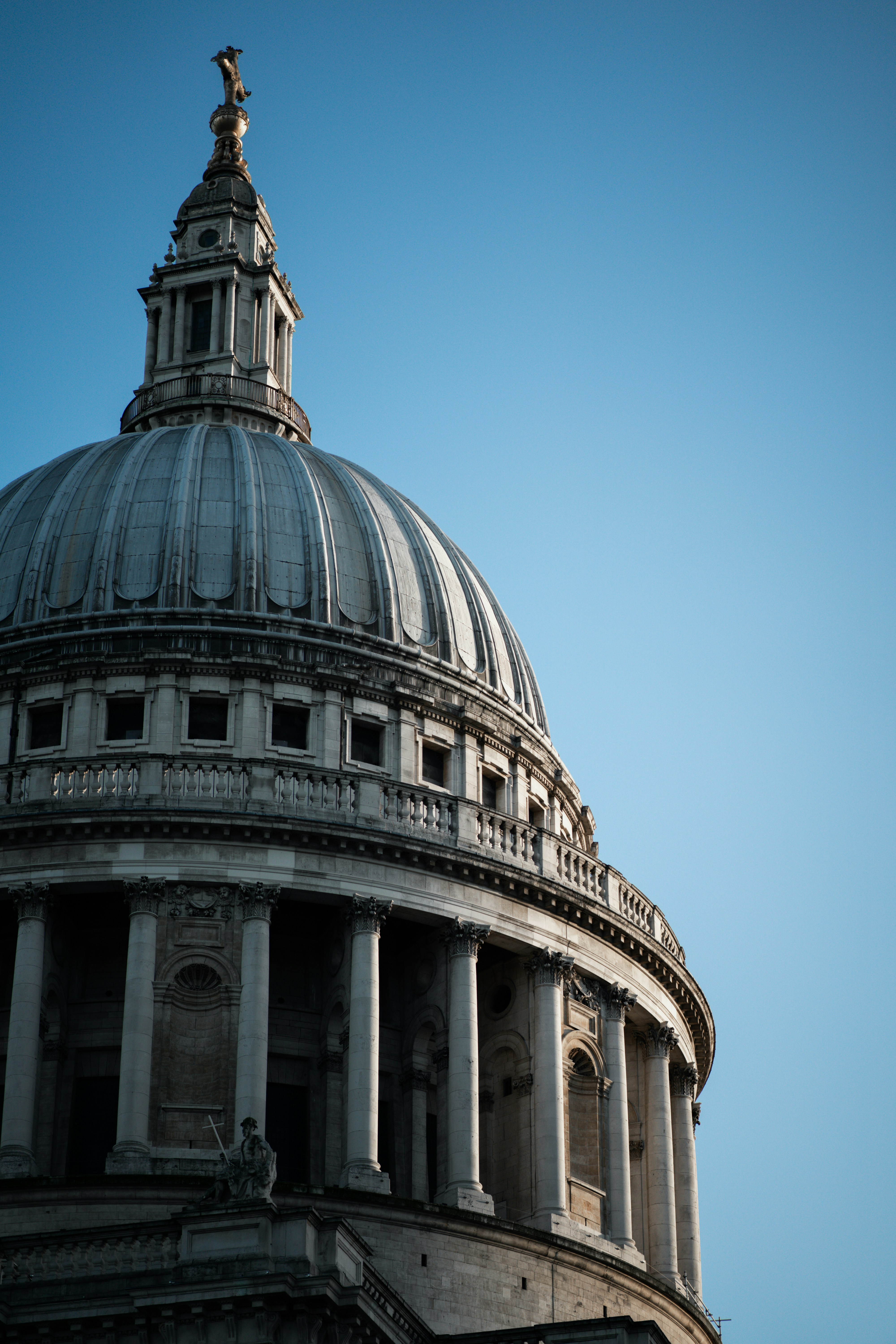 a large building with a domed roof with St Paul's Cathedral in the background