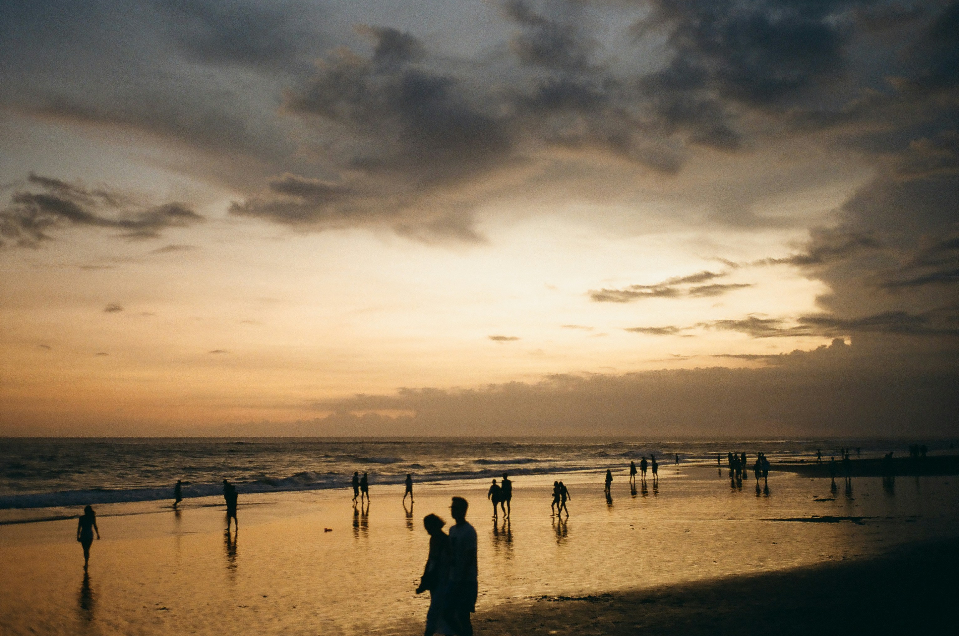People on a Bali beach at sunset