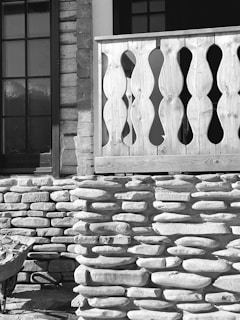 Photograph of a balcony renovation in progress with workers applying new railing and surface