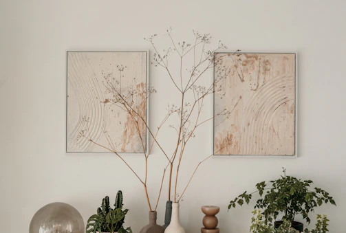 A serene corner featuring aesthetic paintings paired with natural decor elements.