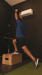 A person performing a dynamic functional training exercise outdoors.