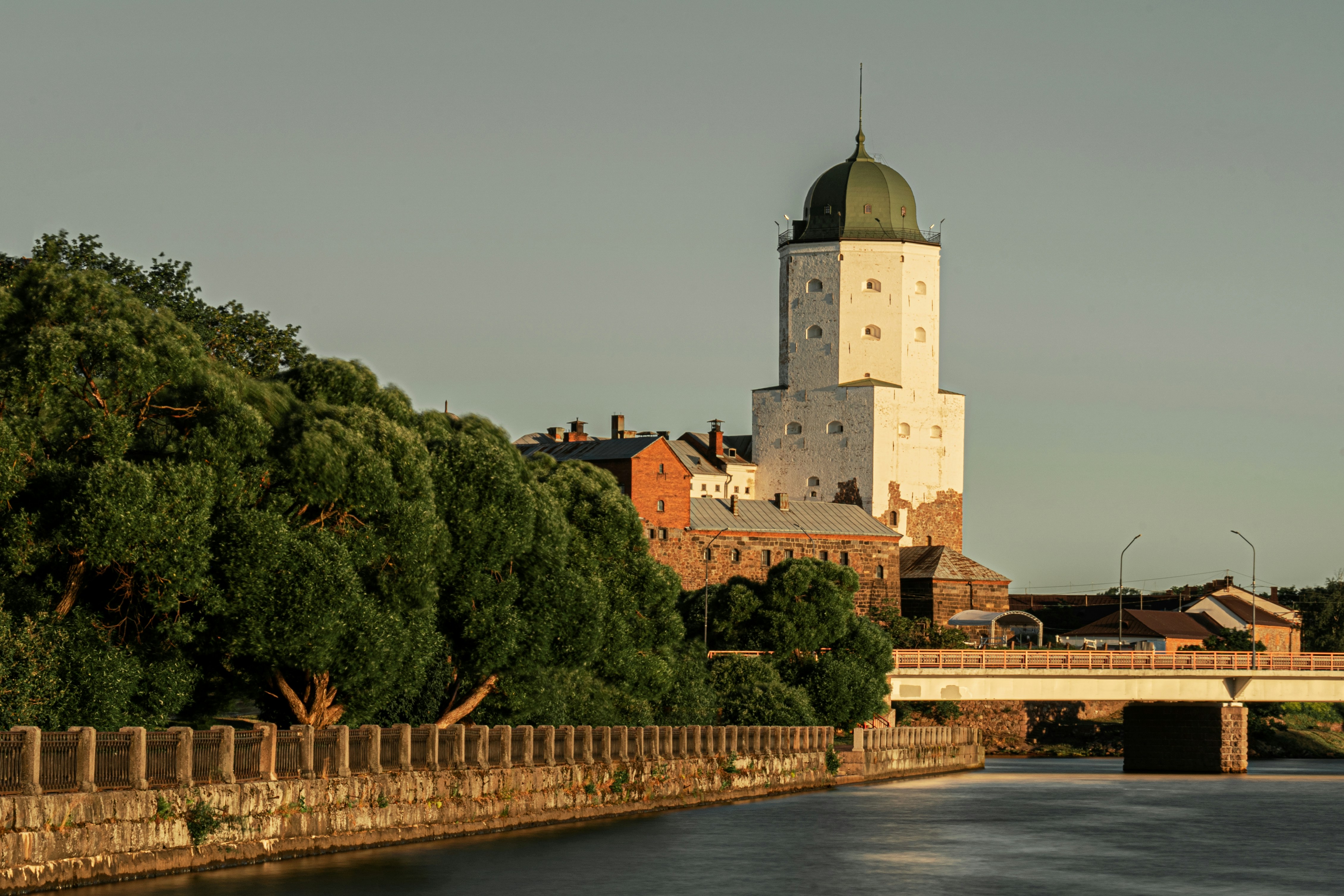 a building with a tower by a river