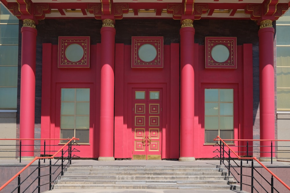 a building with pink pillars