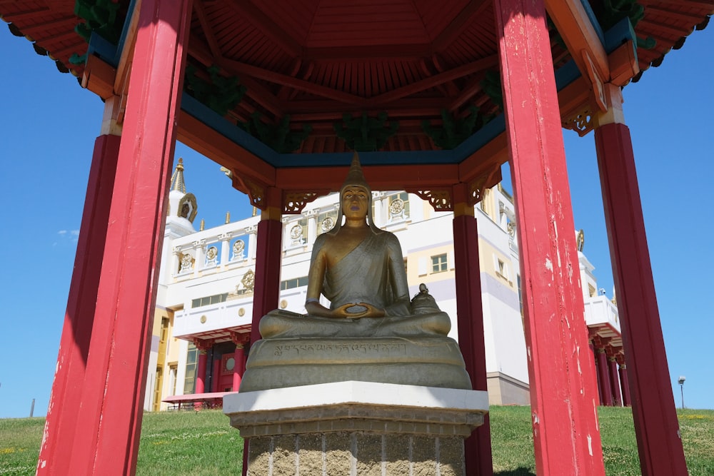 a statue in a red and white structure