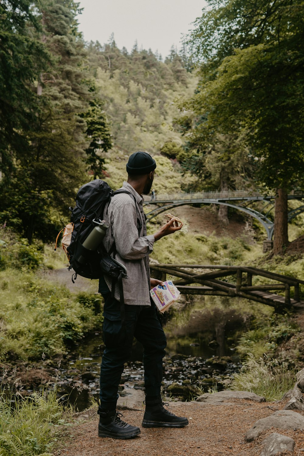 a man with a backpack looking at a phone