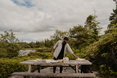 A portable vacuum sealer preserving fresh food on a sunny picnic table surrounded by nature.