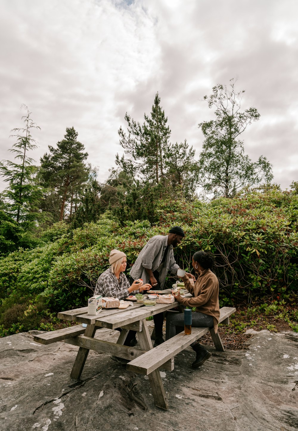 a group of people sitting at a picnic table