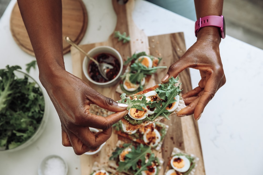 hands holding a plate of food