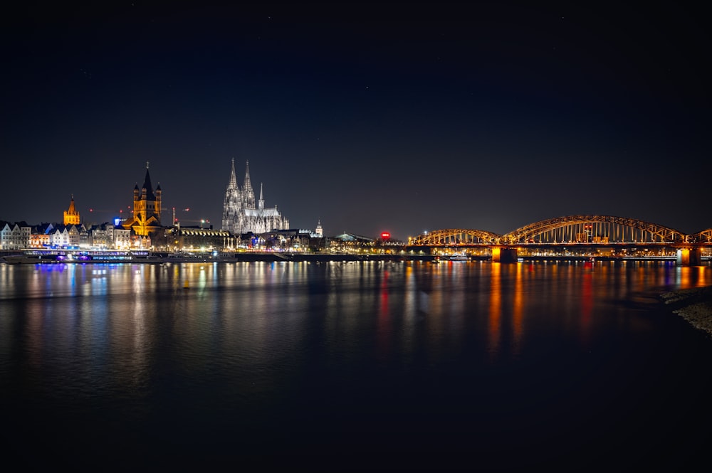 a bridge over water with a city in the background