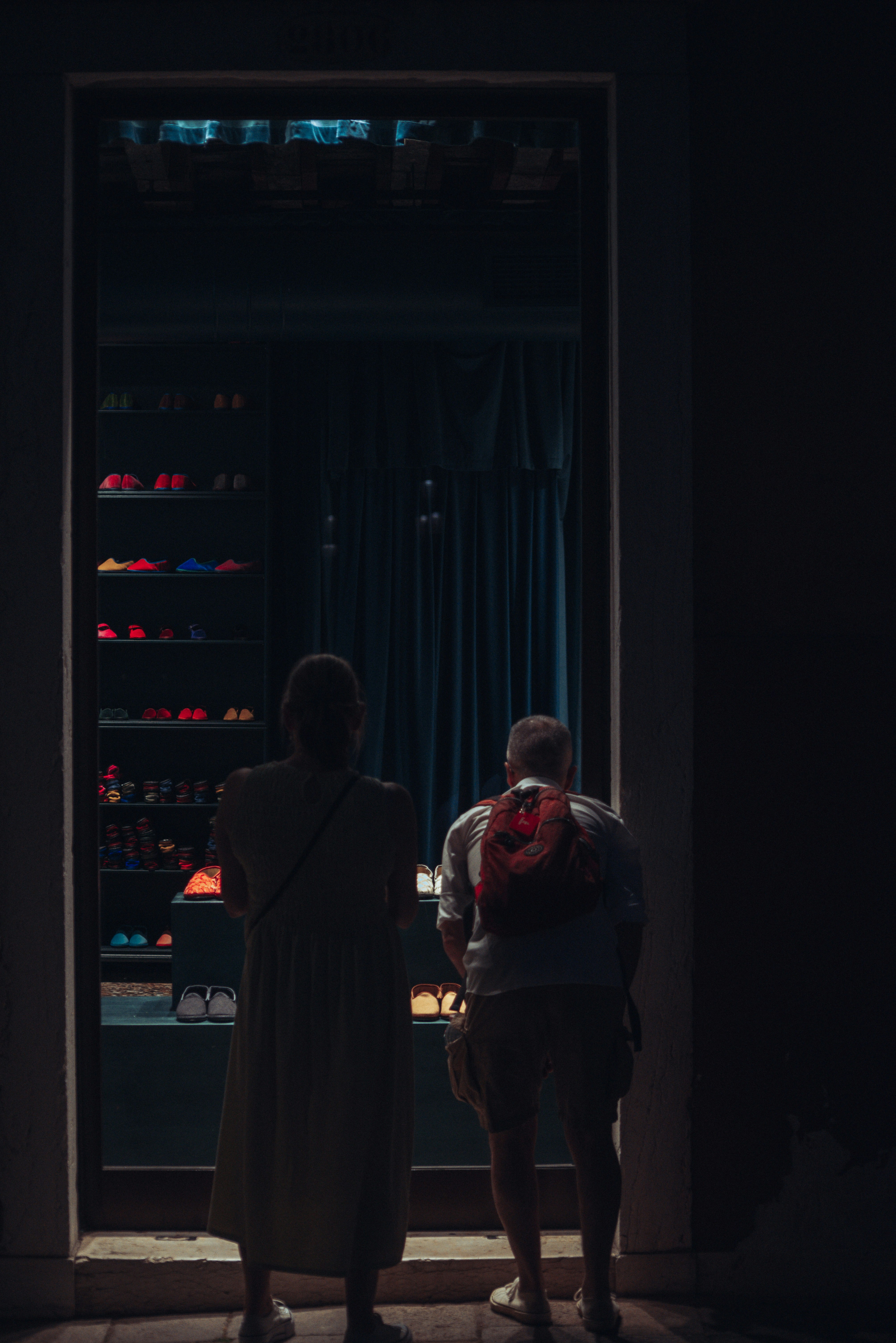 a man and woman standing in front of a large screen