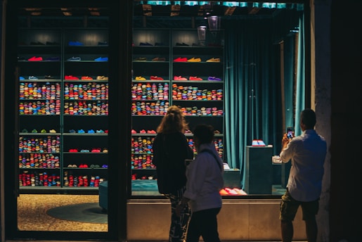 people standing in front of a display of bottles
