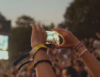 a group of people holding up a cell phone
