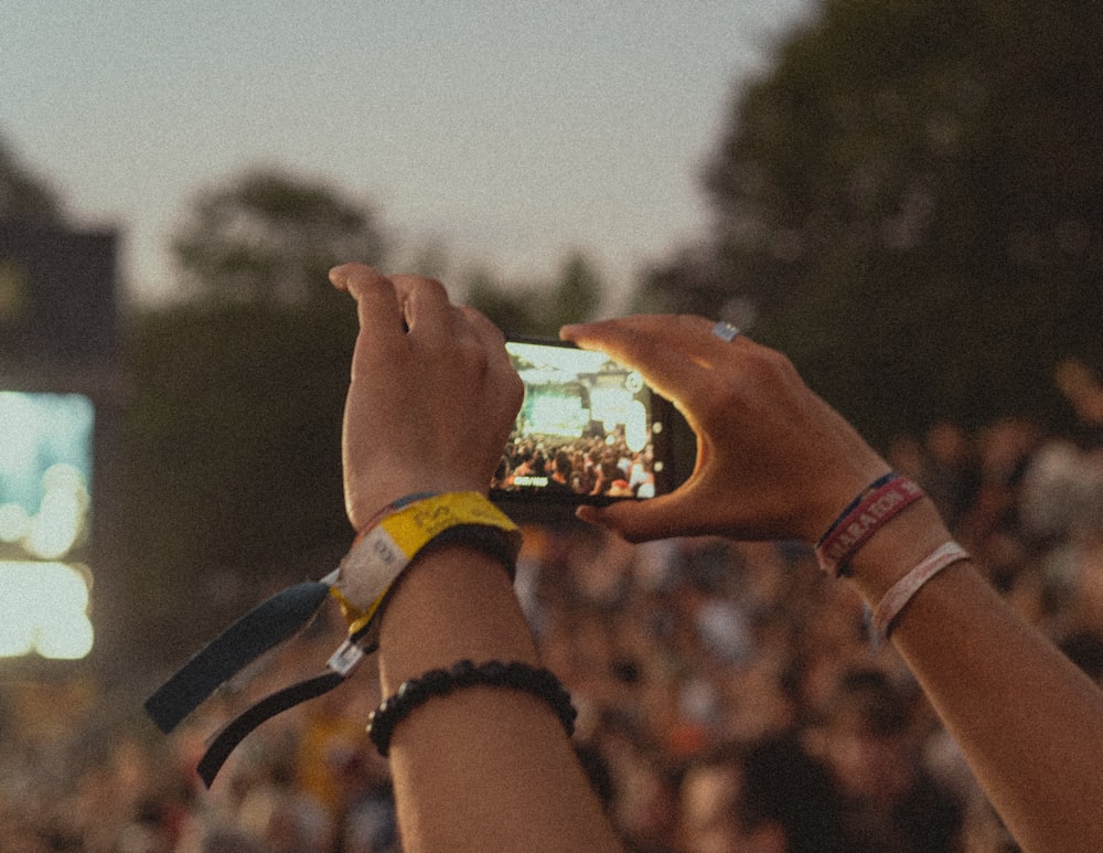 a group of people holding up a cell phone