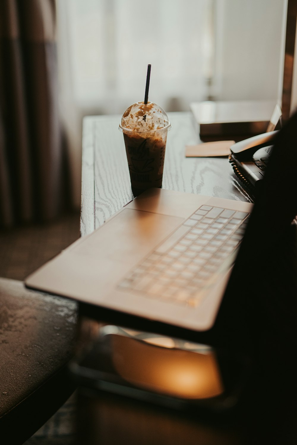 a laptop with a cupcake on top of it