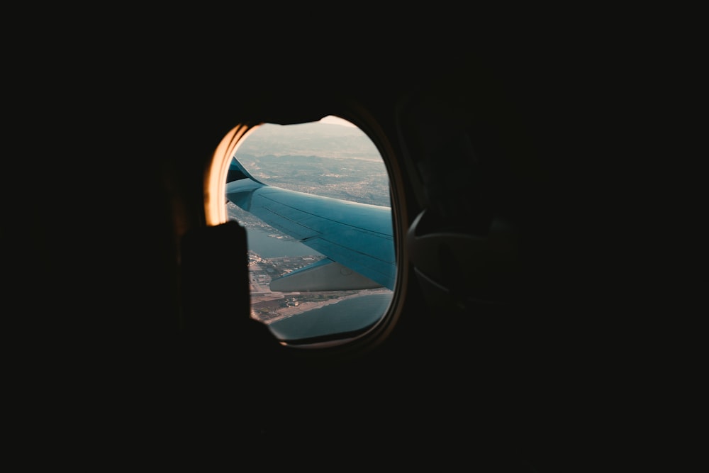an airplane window looking out at the ocean