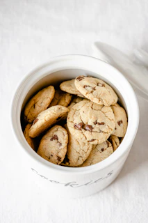 A warm, inviting cookie jar with the Brown Country Investments logo softly glowing on its side.