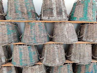 Handwoven rattan baskets arranged neatly on a rustic wooden shelf, bathed in warm natural light.