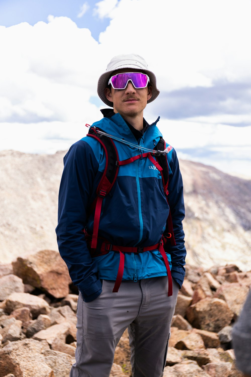 a person wearing a hat and sunglasses