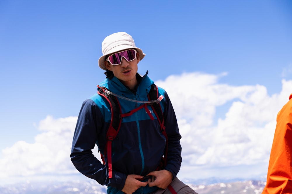 a person wearing a hat and sunglasses