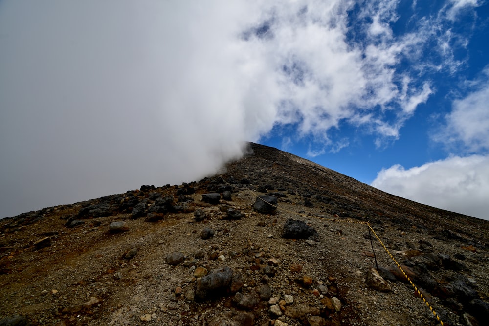 a rocky hill with a rope