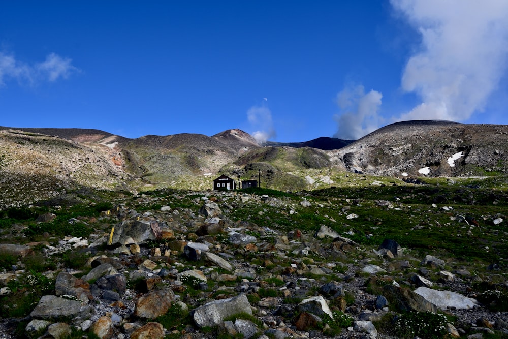 a rocky area with a building in the distance