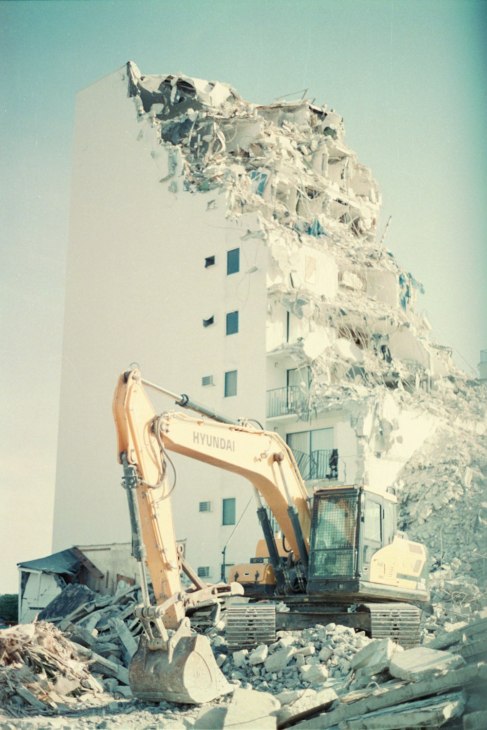 a large white building with a large pile of snow on the ground