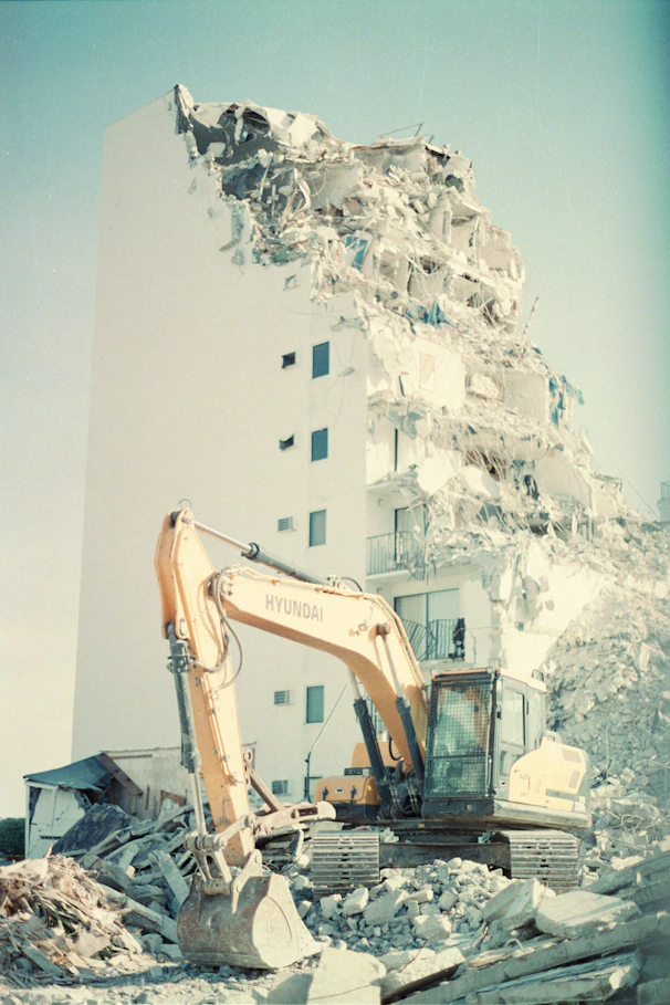 a large white building with a large pile of snow on the ground