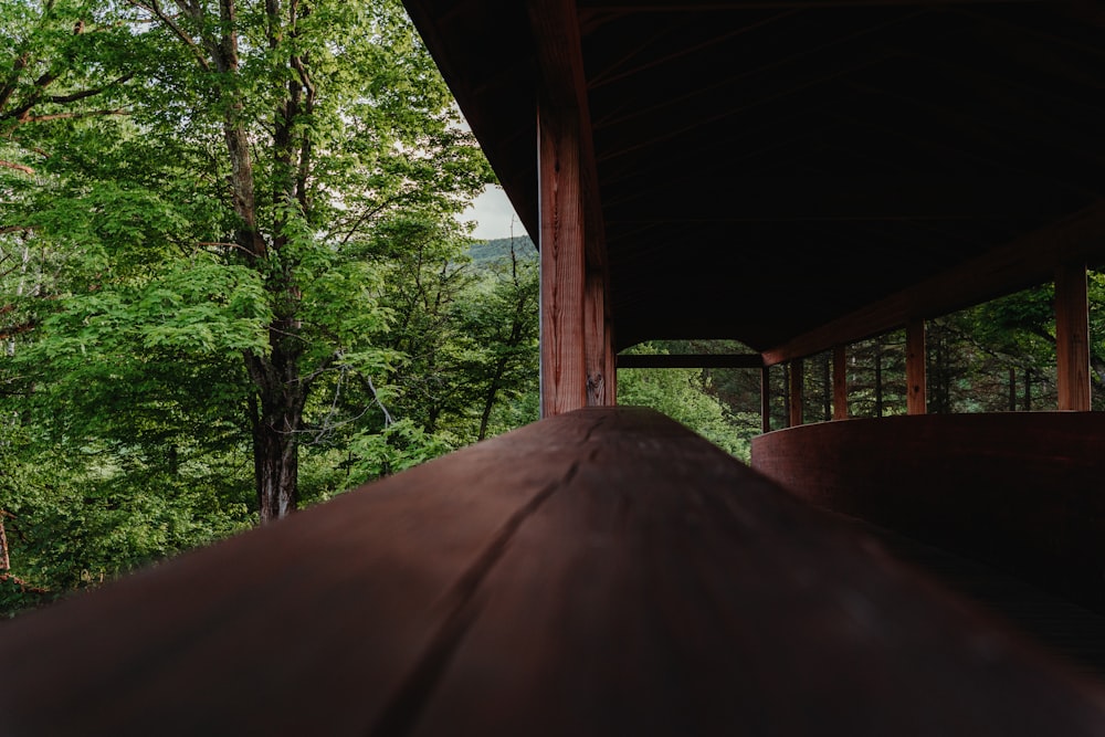 a wooden structure with trees in the background