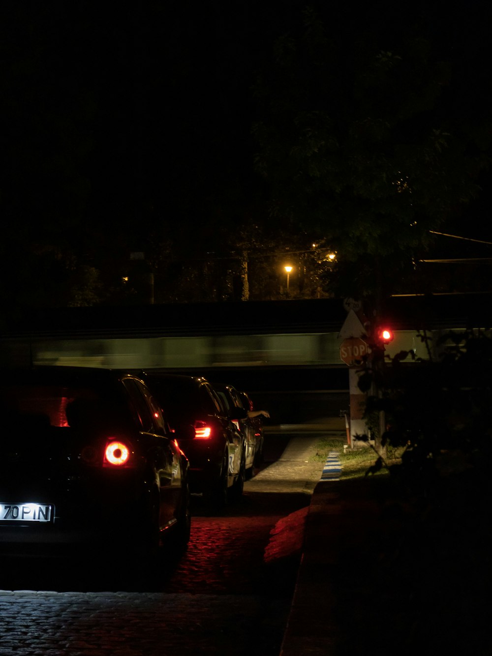 a car parked on the side of a road at night