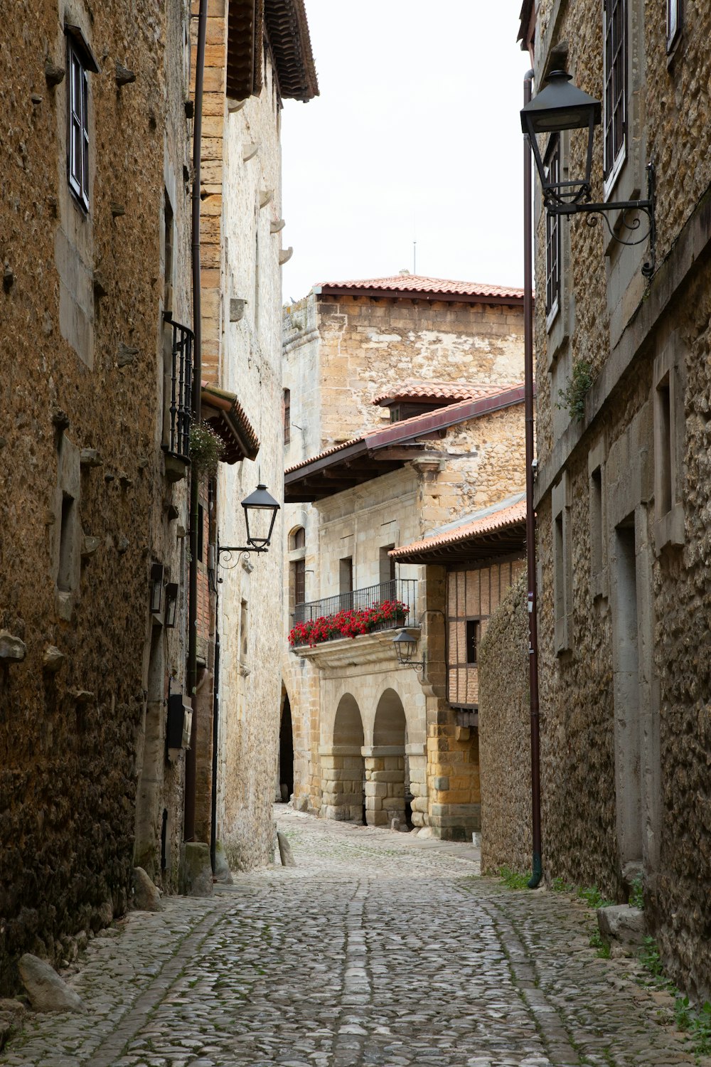 a cobblestone street between buildings