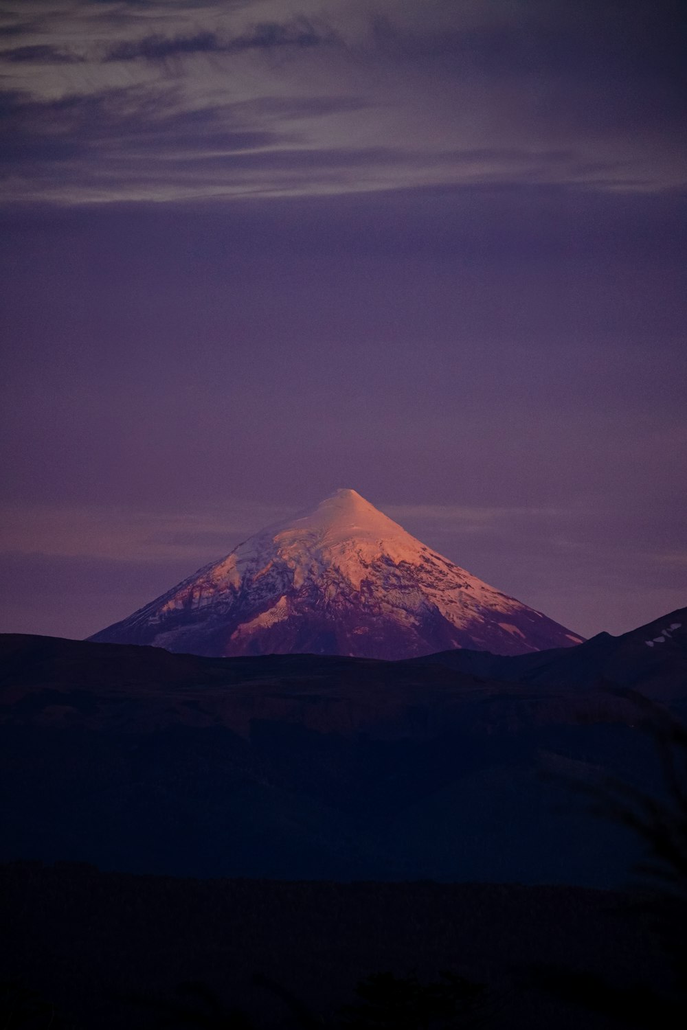 a mountain with a snow capped peak