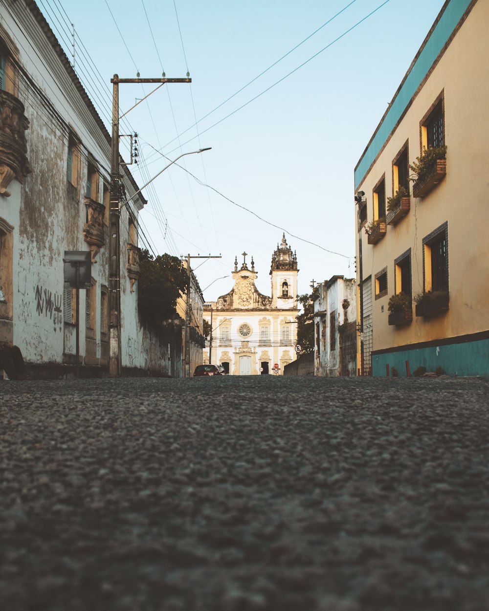 a cobblestone street with buildings on either side of it