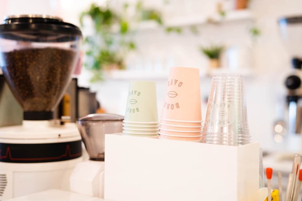 a coffee maker with a coffee cup and a coffee cup