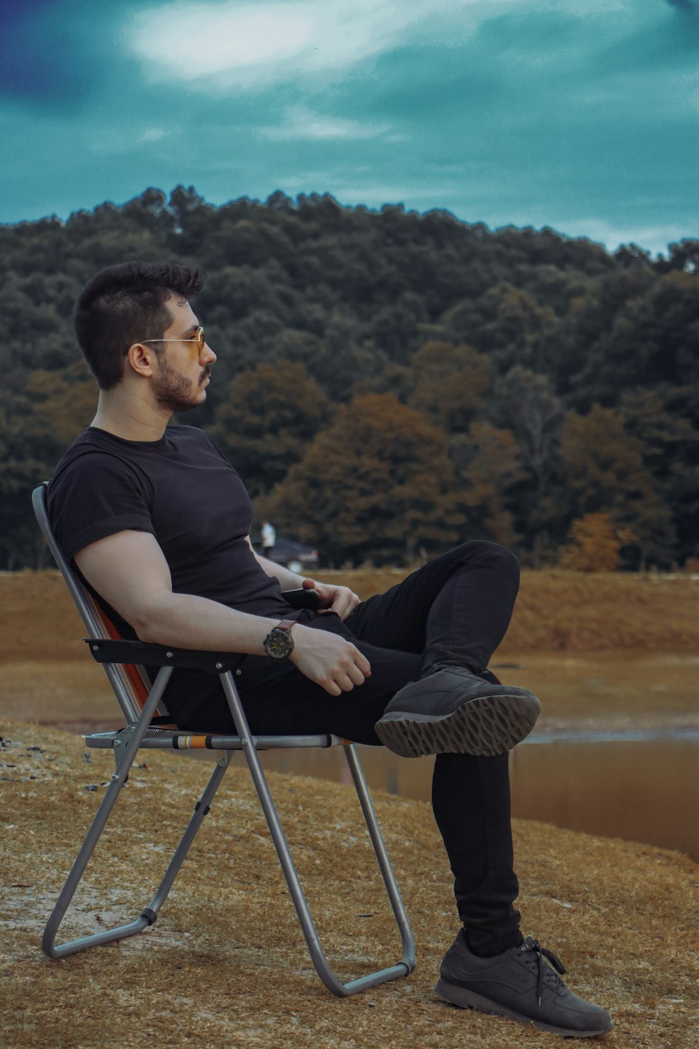 a person sitting in a chair outside