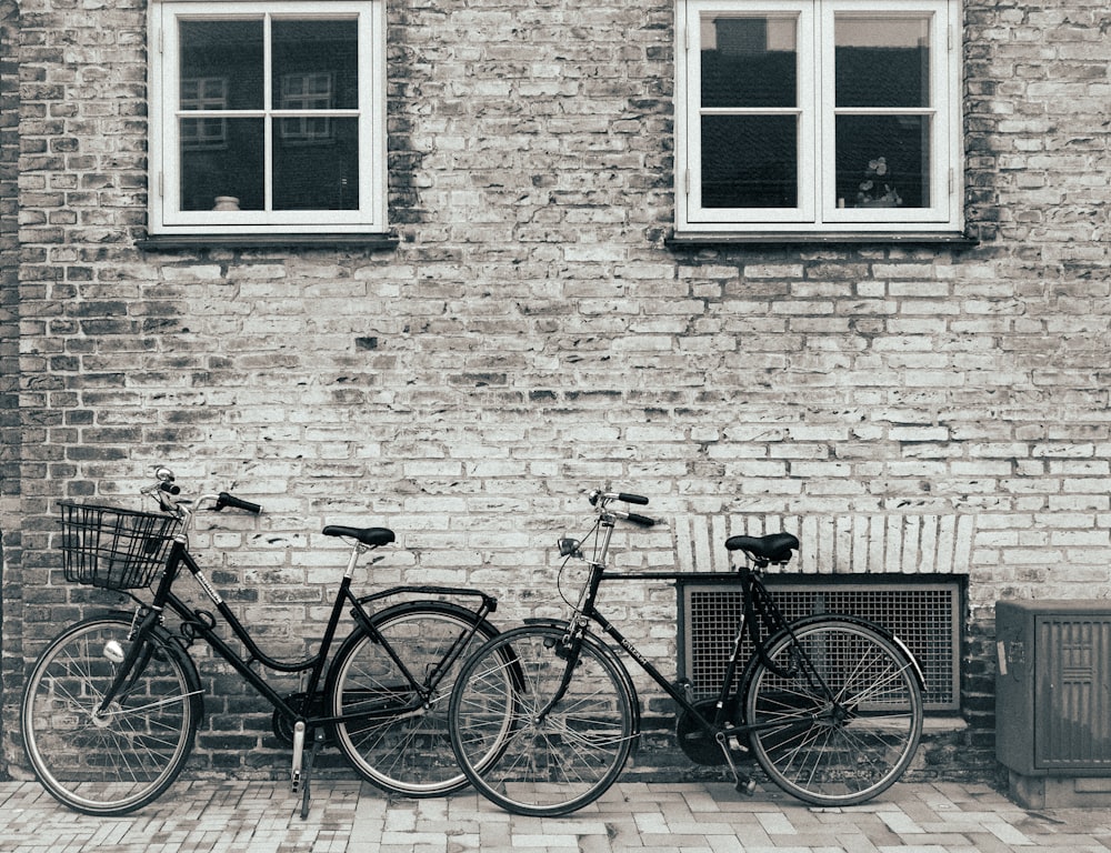 bicycles parked in front of a brick building