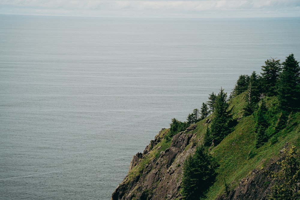 a rocky cliff overlooking a body of water