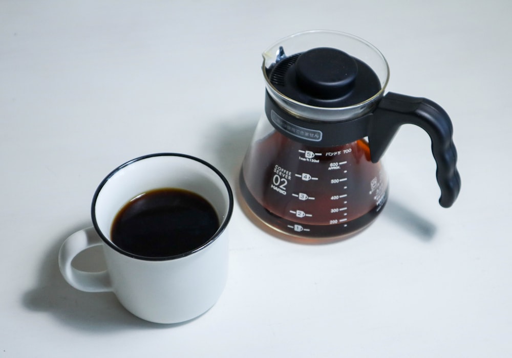 a coffee maker and a mug